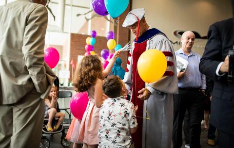 Children greet new MIT doctor in his regalia