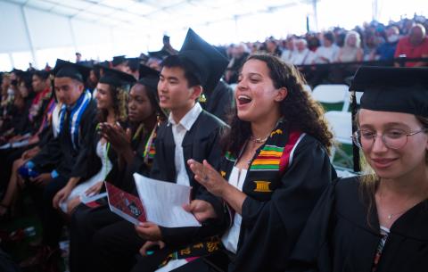 Image of graduates cheering in the crowd at the Undergraduate Ceremony