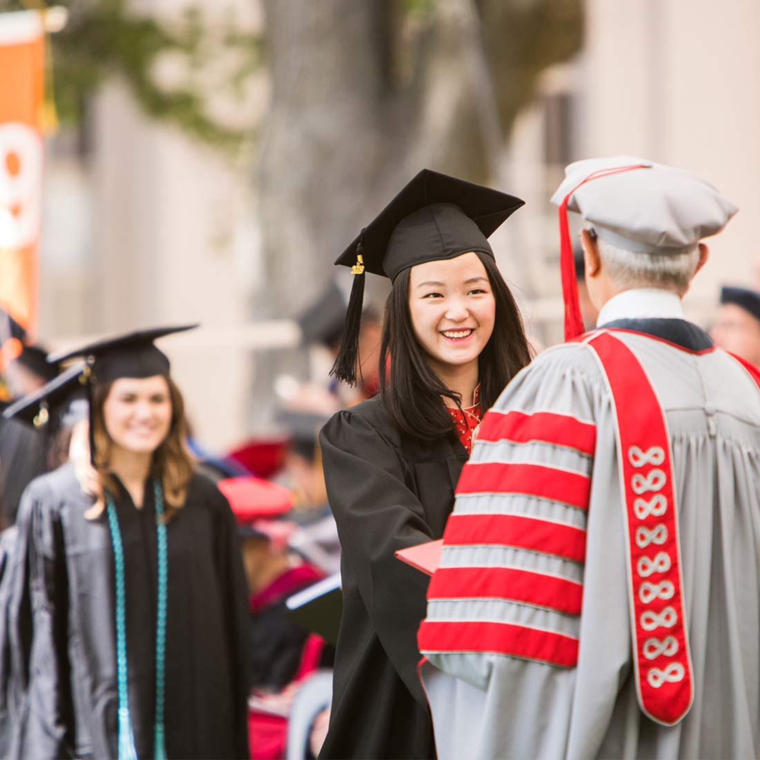 A student receives her degree from MIT President L. Rafael Reif; photo: Jake Belcher