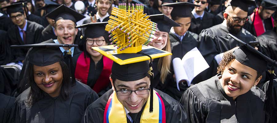 A graduate shows off his unique mortar board, which contains a three-dimensional sculpture made of pencils; photo: Dominick Reuter