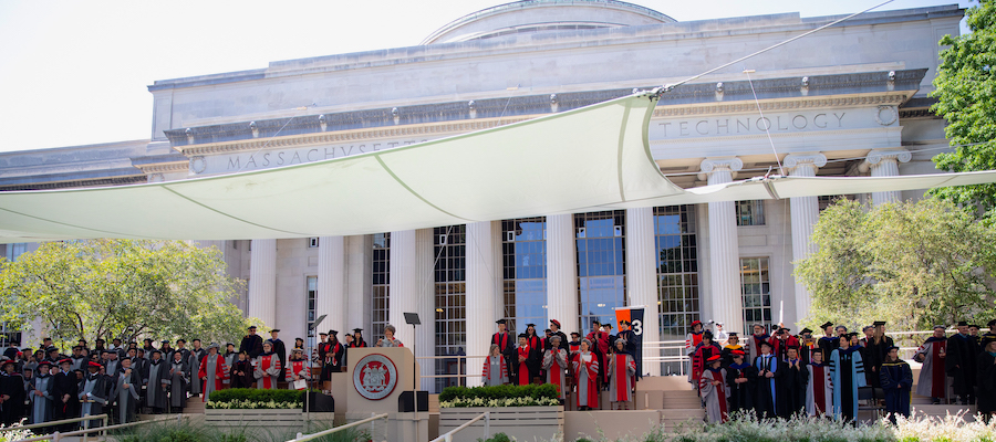 Image of the Killian Court Commencement stage. Building 10 and the great dome is seen in the background.
