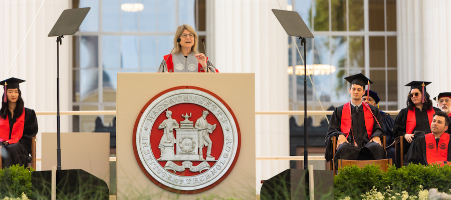Image of President Sally Kornbluth speaking at the podium which shows the MIT seal