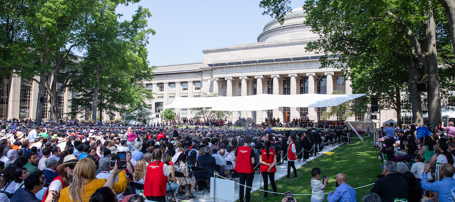 Image of the audience in Killian Court looking towards the ceremony stage during the Commencement ceremony