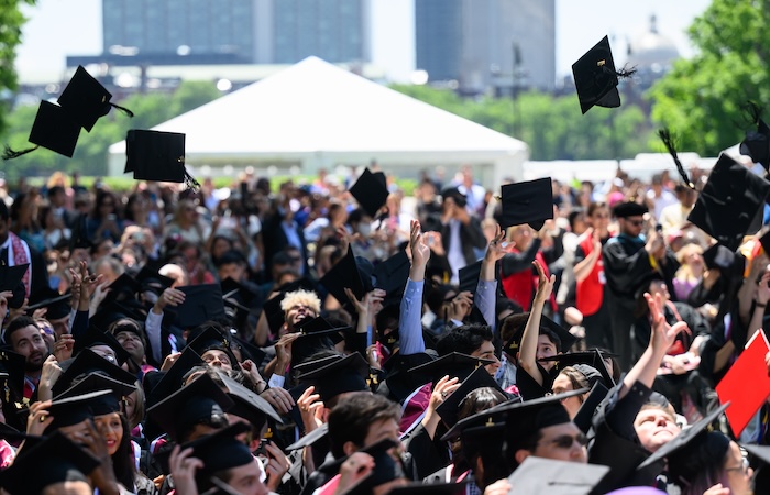 Image of graduates throwing their caps at the end of the Undergraduate Ceremony