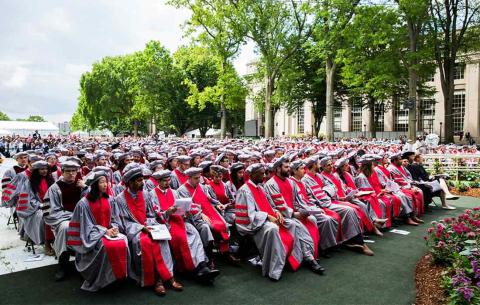 Overview image of Doctoral candidates seated in Killian Court in their regalia; photo: Jake Belcher