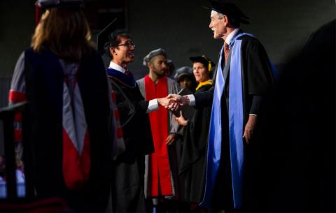 PhD shaking faculty member's hand