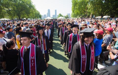 Image of the graduate dicision of the academic procession. Graduates are in a double-file line. 