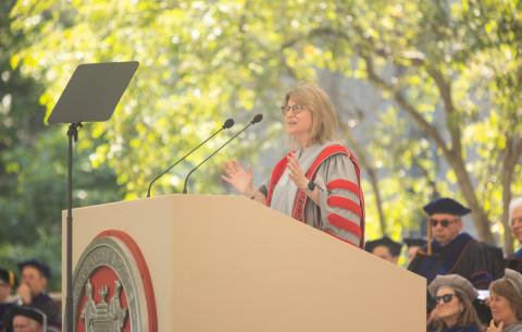 Image of President Sally Kornbluth at the podium delivering her charge to the graduates