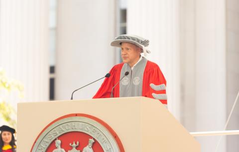 Image of Stephen D. Baker in full regalia at the podium delivering his welcome to the MIT Alumni Association