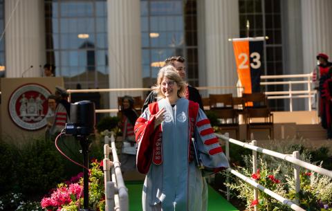 Image of President Sally Kornbluth smiling and leaving the stage after the OneMIT Commencement Ceremony