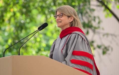 Image of President Sally Kornbluth at the podium delivering her charge to the graduates