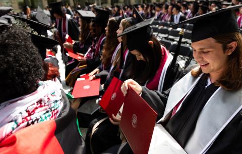 Image of graduates with their diploma cases during the Undergraduate Ceremony